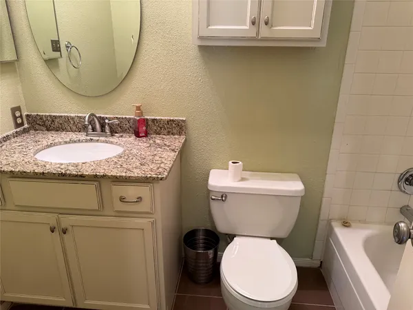 an empty room with wooden floor and windows with curtains
