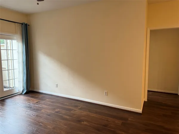 an empty room with wooden floor and closet