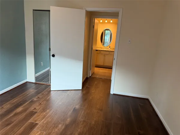 an empty room with wooden floor and a window