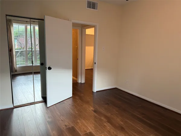 a bathroom with a toilet mirror and sink