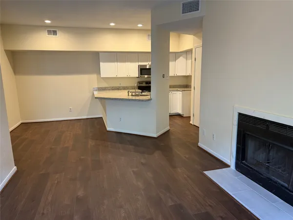 a view of kitchen cabinets and wooden floor