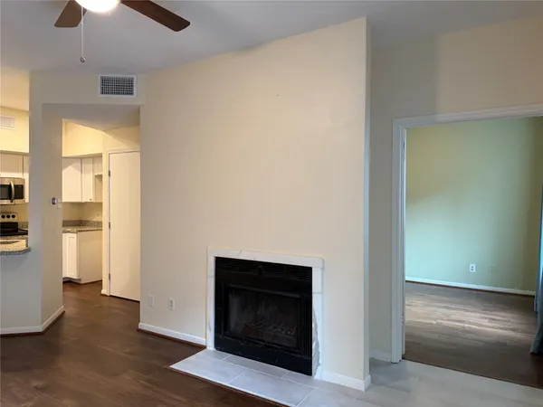 a room with wooden floor and a fireplace