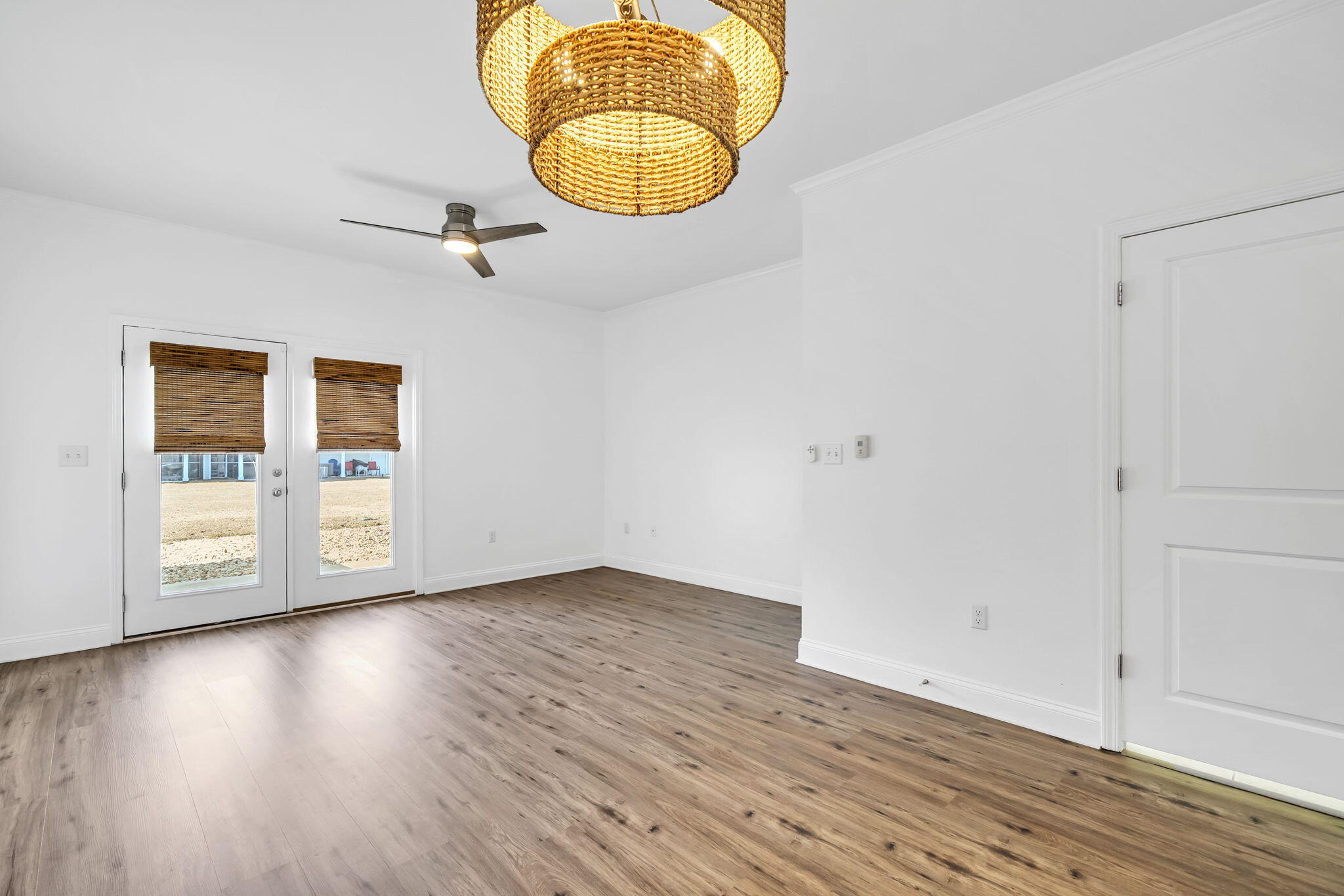 29 North Sand Palm Road Freeport, FL 32439 - Photo 32 of 40 an empty room with wooden floor and windows