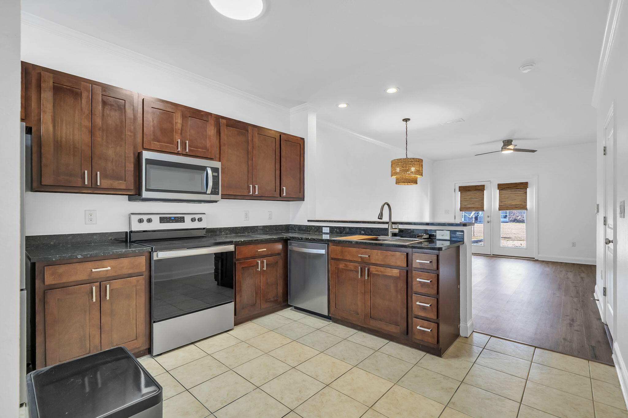 29 North Sand Palm Road Freeport, FL 32439 - Photo 4 of 40 a kitchen with stainless steel appliances granite countertop a stove top oven a sink dishwasher and a microwave oven on the blue kitchen countertops