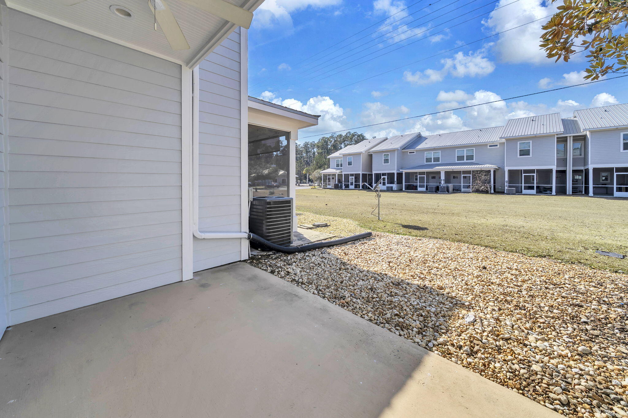 29 North Sand Palm Road Freeport, FL 32439 - Photo 9 of 40 a view of a big house with a big yard and large tree