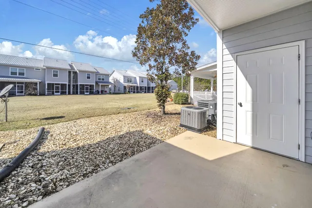 a view of a house with a yard and pathway