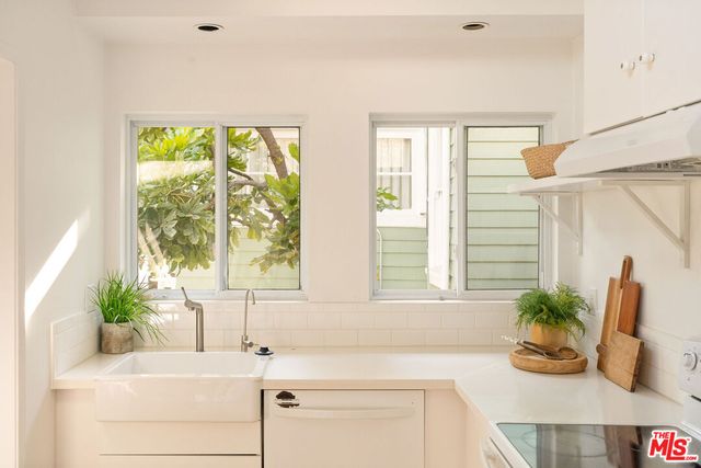 a bathroom with a sink a mirror and a window