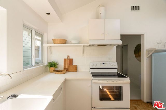 a kitchen with a stove and a refrigerator