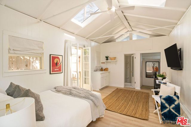 a bedroom with a bed and a large window with outer view