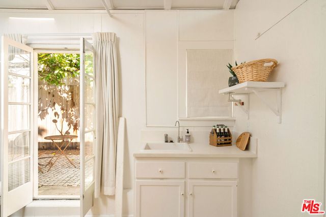 a bathroom with a granite countertop sink a toilet and shower