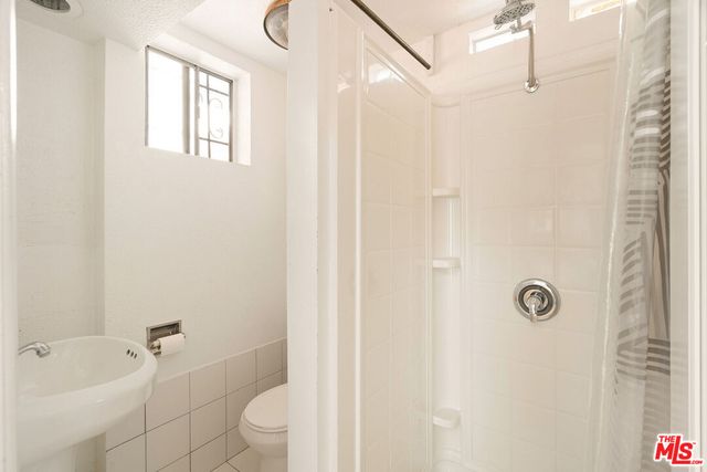 a bedroom with a bed and glass door