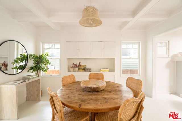 a view of a dining room with furniture and a potted plant