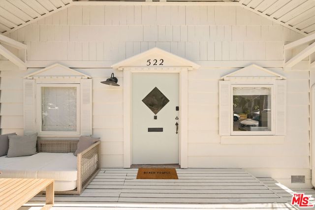 a view of a hallway with entryway wooden floor and front door