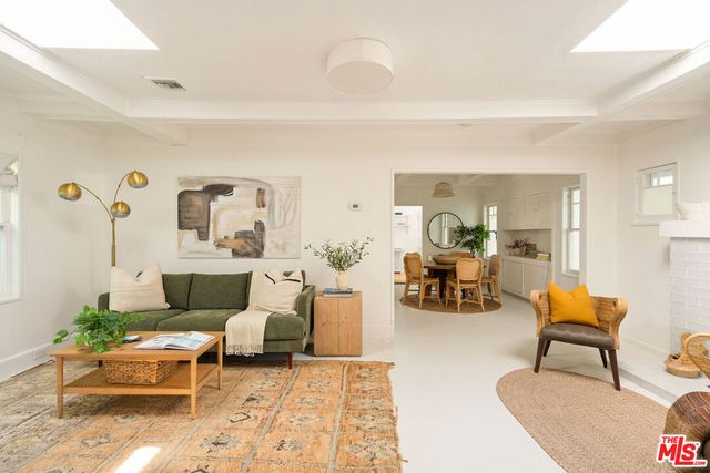 a living room with furniture and a lamp