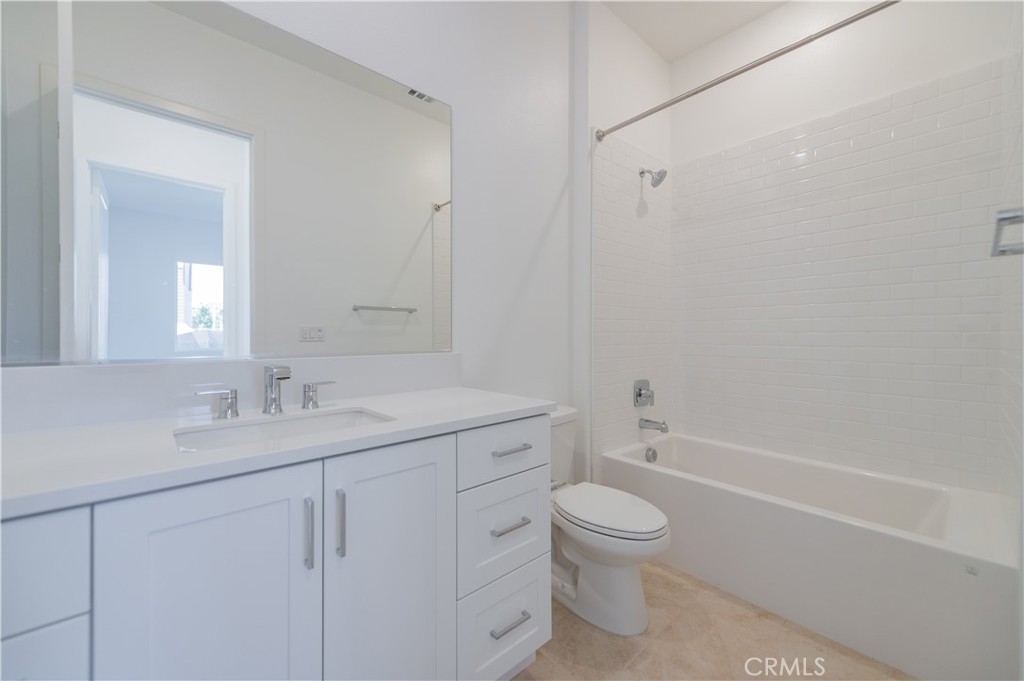 414 Treble Irvine, CA 92618 - Photo 13 of 34 a bathroom with a granite countertop toilet a sink and a bathtub