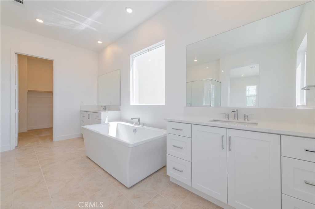 414 Treble Irvine, CA 92618 - Photo 18 of 34 a bathroom with double vanity sink a mirror and a bathtub