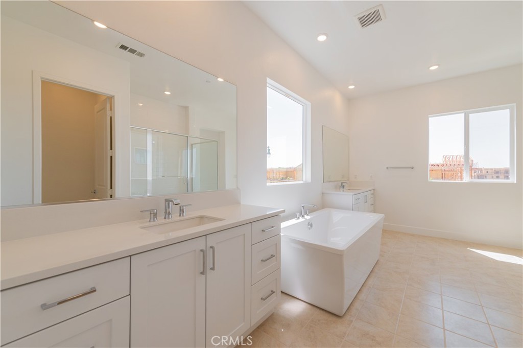 414 Treble Irvine, CA 92618 - Photo 19 of 34 a bathroom with a sink double vanity tub and a mirror