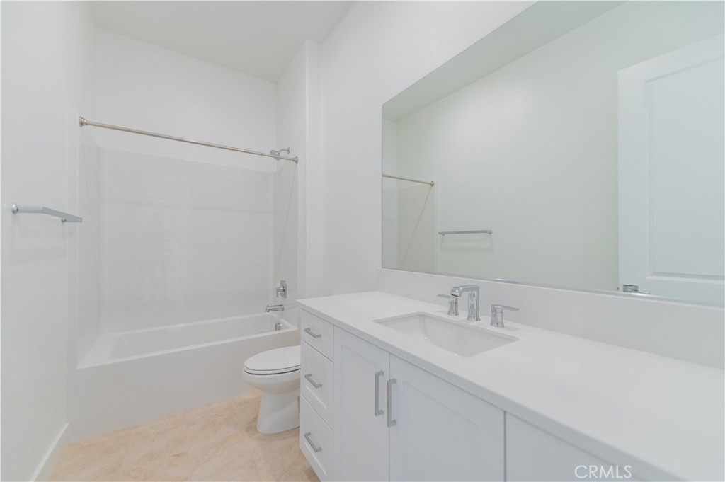 414 Treble Irvine, CA 92618 - Photo 26 of 34 a bathroom with a granite countertop sink a toilet and shower