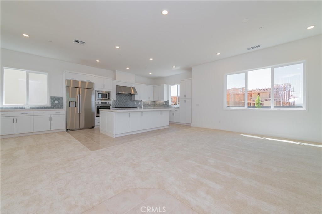 414 Treble Irvine, CA 92618 - Photo 4 of 34 a view of a kitchen with a sink a refrigerator and window