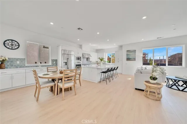 a large kitchen with a table and chairs
