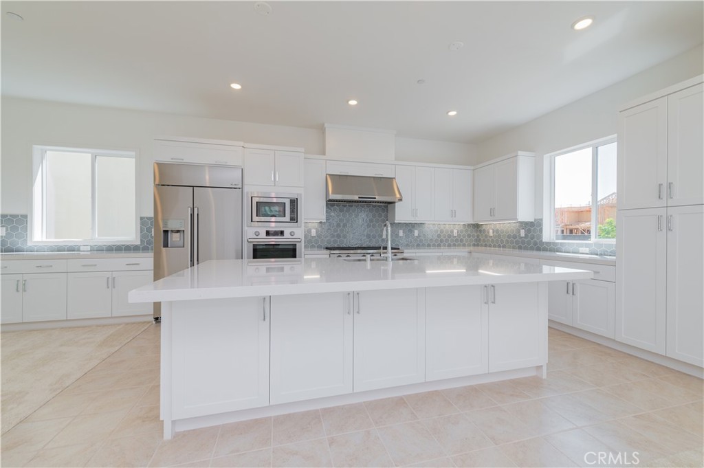 414 Treble Irvine, CA 92618 - Photo 7 of 34 a kitchen with stainless steel appliances granite countertop a sink and white cabinets