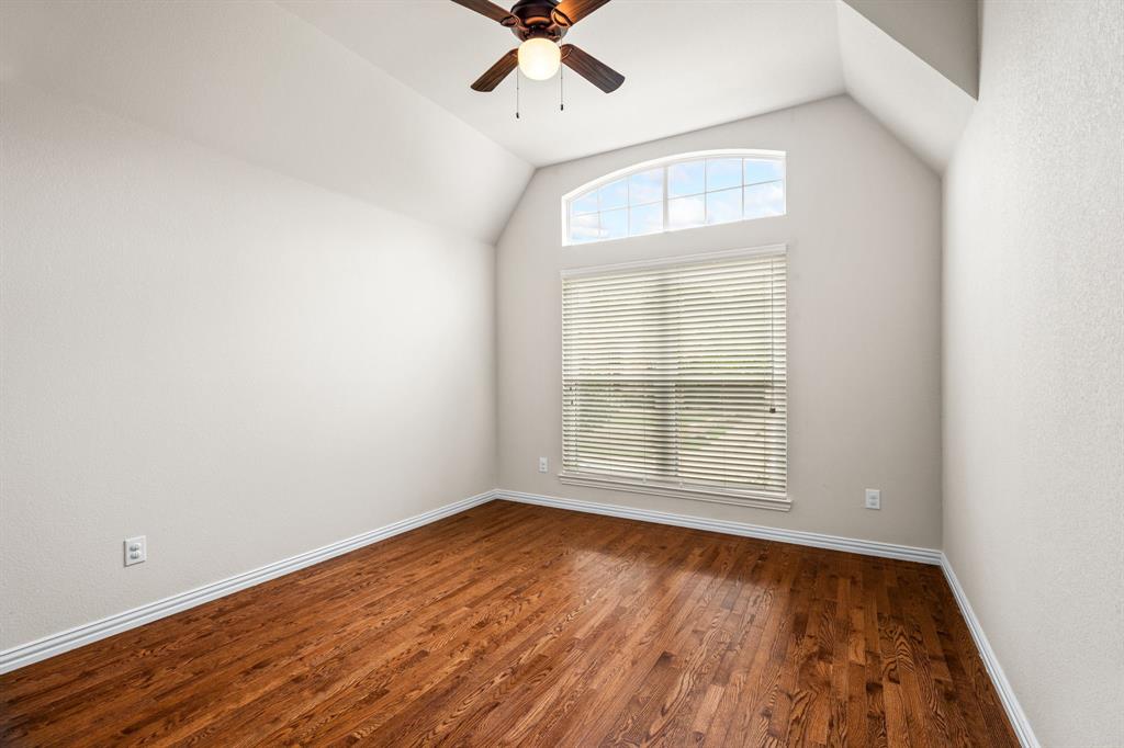 2012 Burnside Drive Allen, TX 75013 - Photo 32 of 40 an empty room with wooden floor chandelier fan and windows