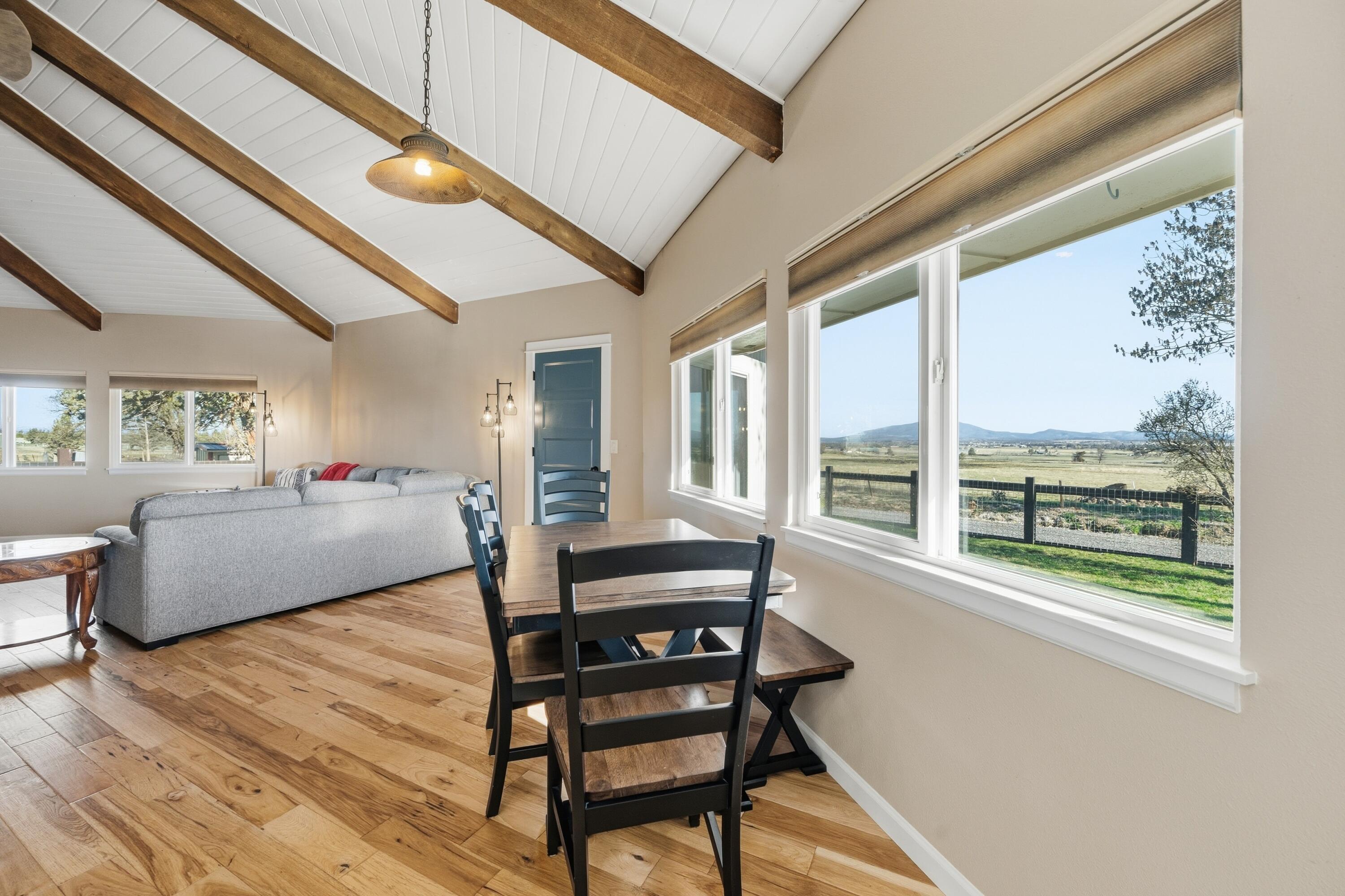 4074 Southwest Reif Road Powell Butte, OR 97753 - Photo 10 of 59 a bedroom with furniture and a large window