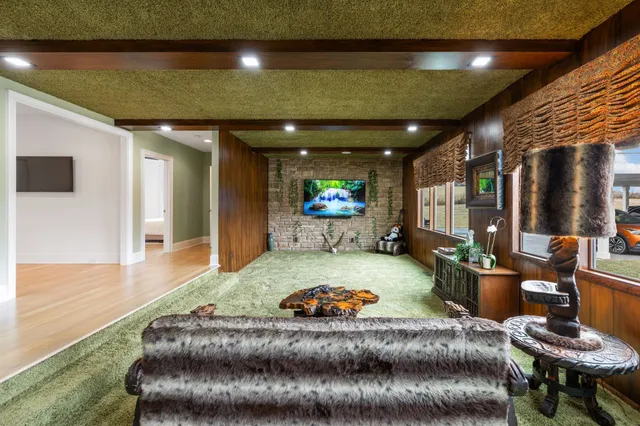 a living room with furniture and a chandelier