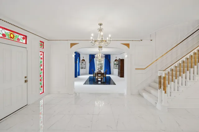 a view of a dining room with furniture and chandelier