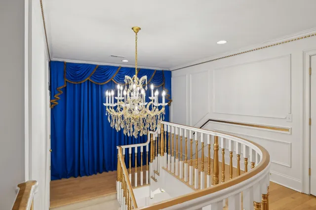 a room with a bed and a chandelier