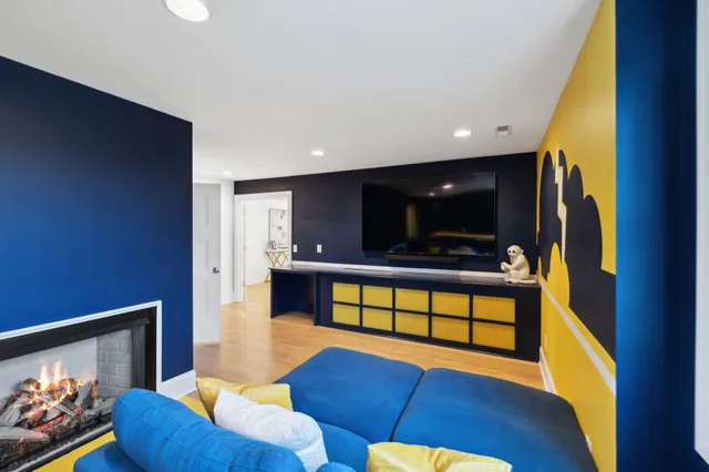 a bedroom with a bed and a flat tv screen on dresser
