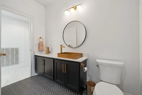 a bedroom with a bed and a flat tv screen on dresser