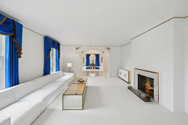 a living room with furniture and a painting on the wall