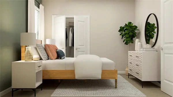 a bedroom with a bed and a potted plant