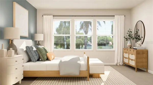 a bedroom with a bed and a large window