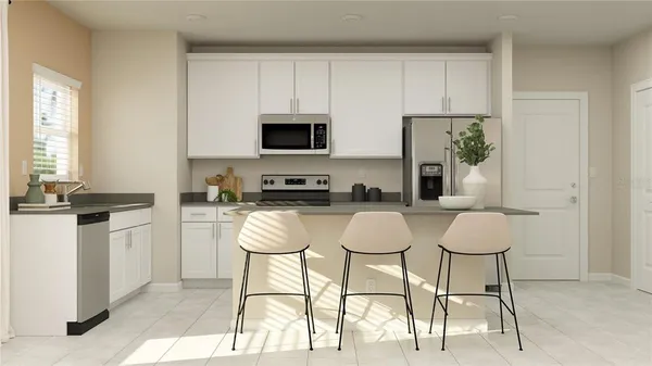 a kitchen with stainless steel appliances a stove a sink cabinets and a dining table