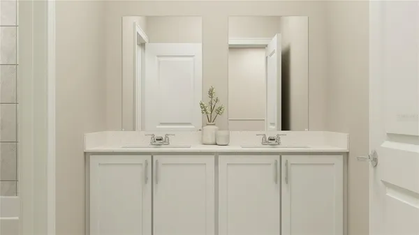 a bathroom with 2 sink and a mirror