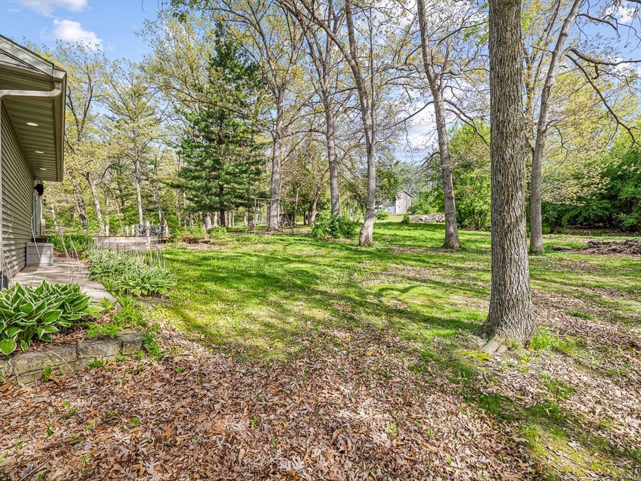 7785 Prairie Hill Road South Beloit, IL 61080 - Photo 11 of 46 a view of a backyard with large trees