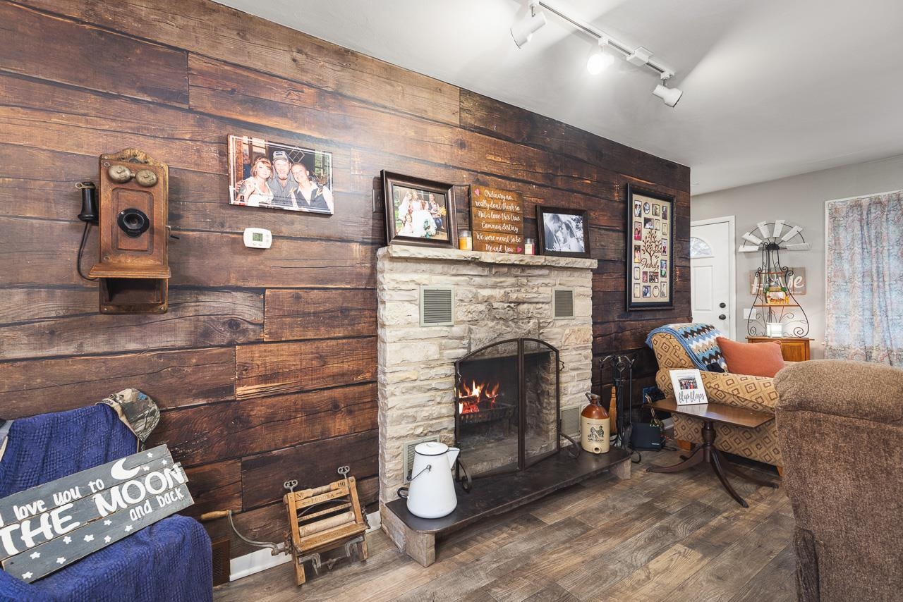 7785 Prairie Hill Road South Beloit, IL 61080 - Photo 15 of 46 a living room with furniture and a fireplace