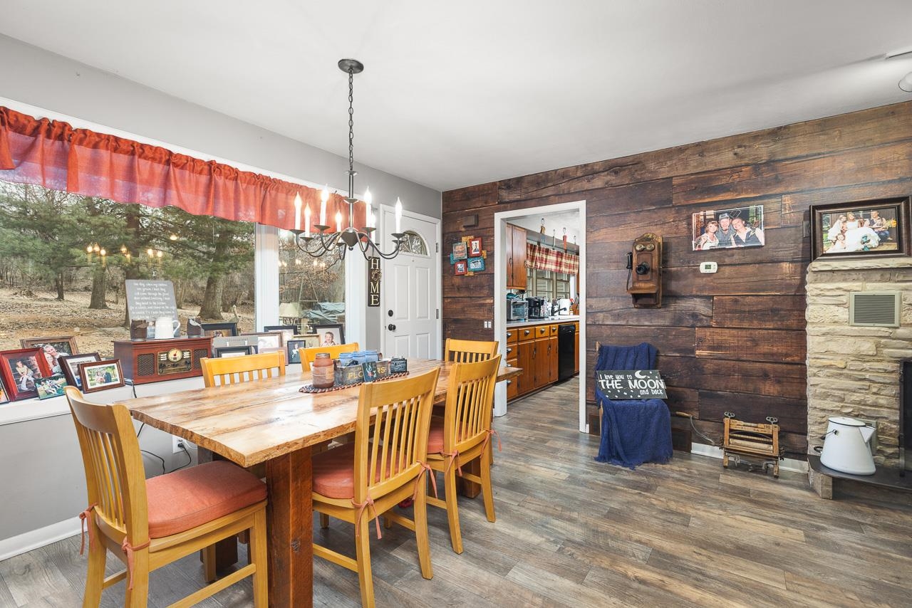 7785 Prairie Hill Road South Beloit, IL 61080 - Photo 18 of 46 a dining room with furniture a chandelier and wooden floor