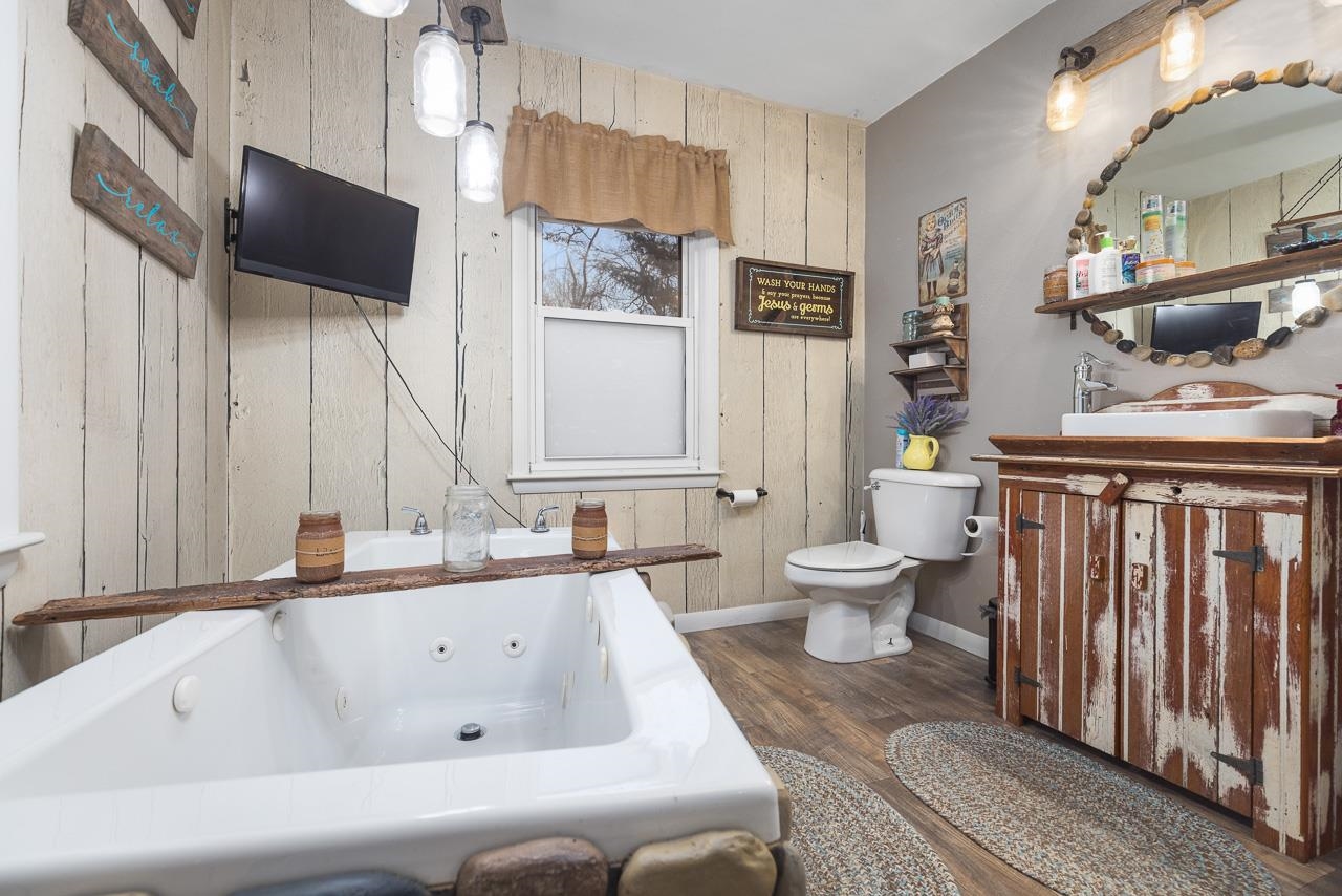 7785 Prairie Hill Road South Beloit, IL 61080 - Photo 22 of 46 a bathroom with a toilet sink and mirror