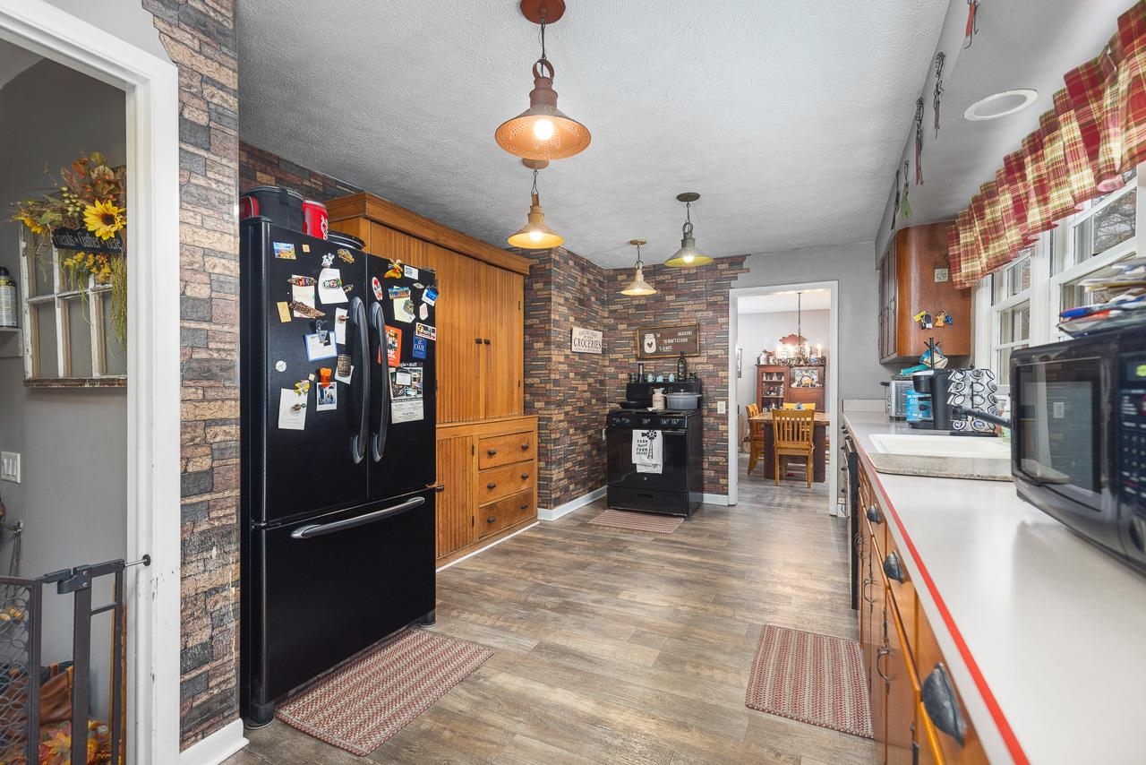 7785 Prairie Hill Road South Beloit, IL 61080 - Photo 28 of 46 a kitchen with stainless steel appliances kitchen island granite countertop a refrigerator and a stove