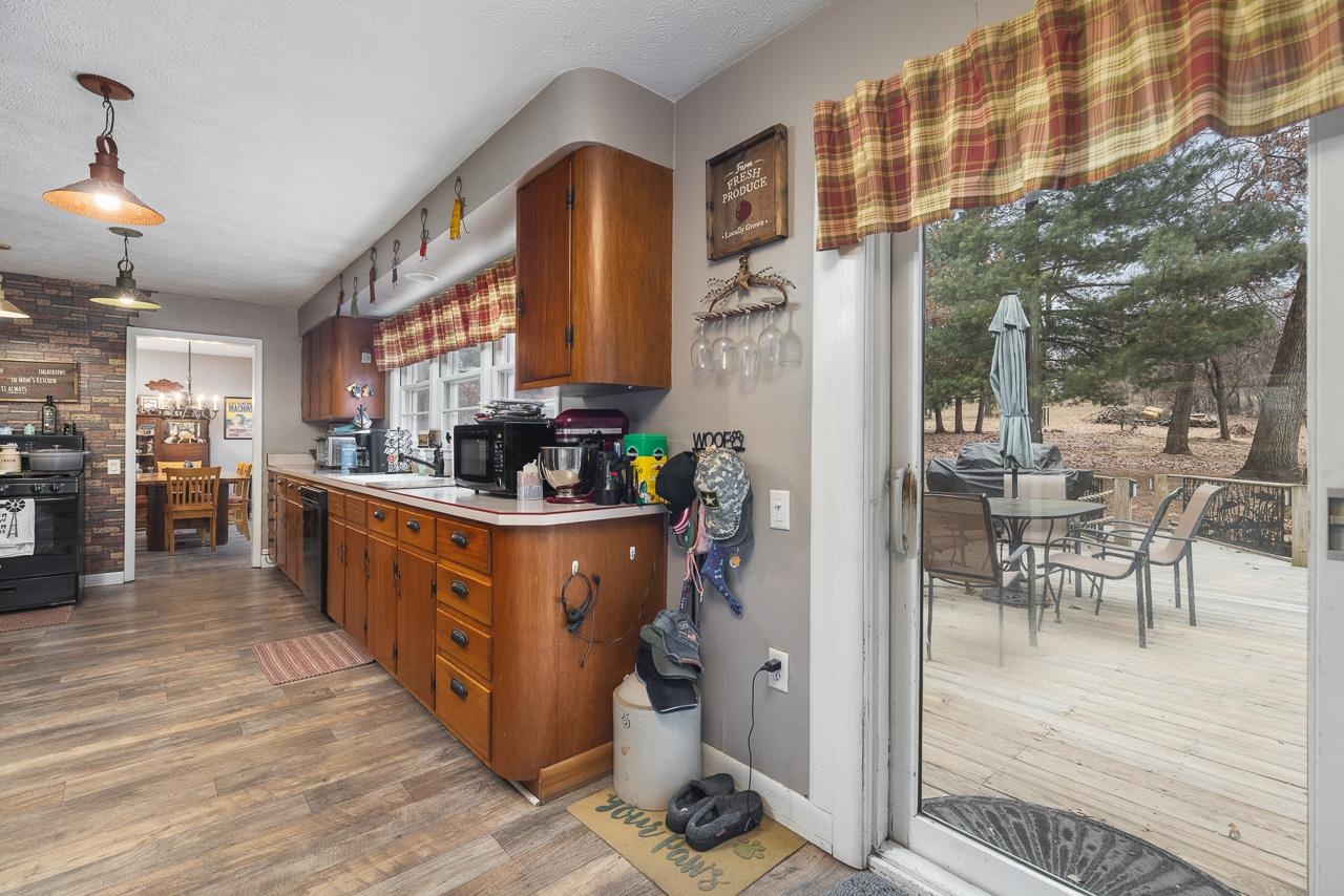 7785 Prairie Hill Road South Beloit, IL 61080 - Photo 29 of 46 a open kitchen with stainless steel appliances granite countertop a stove and a refrigerator