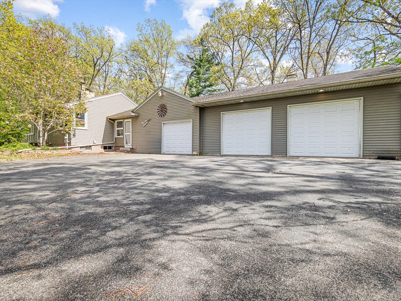 7785 Prairie Hill Road South Beloit, IL 61080 - Photo 3 of 46 a house that has a tree in front of it