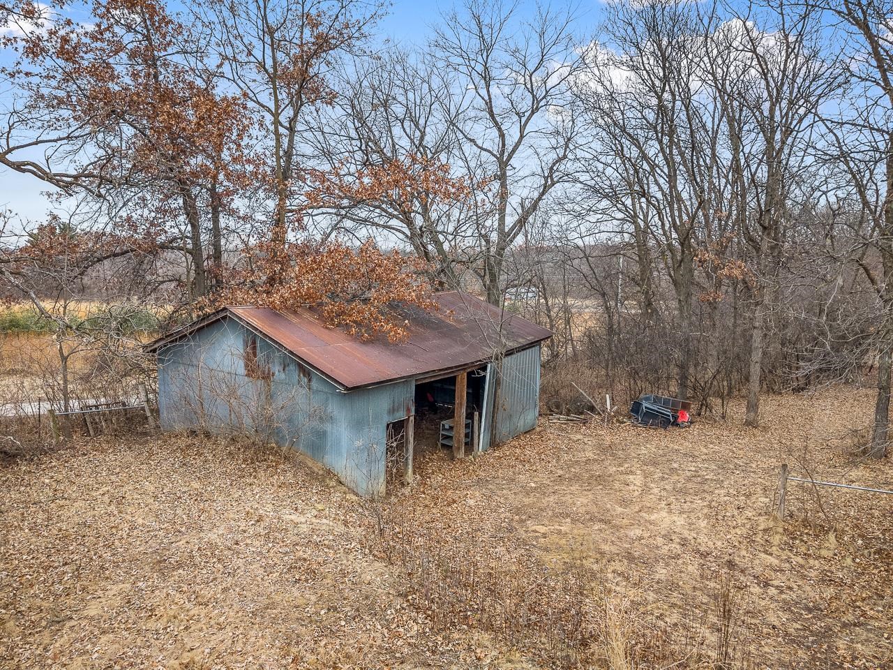 7785 Prairie Hill Road South Beloit, IL 61080 - Photo 39 of 46 a view of a house with a large tree and a yard