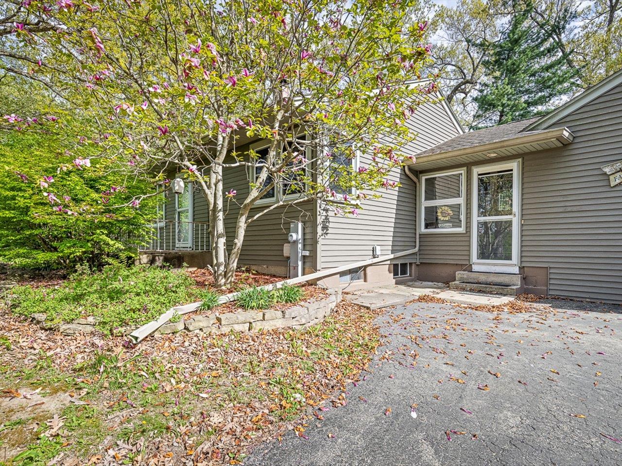 7785 Prairie Hill Road South Beloit, IL 61080 - Photo 4 of 46 a house with trees in front of it