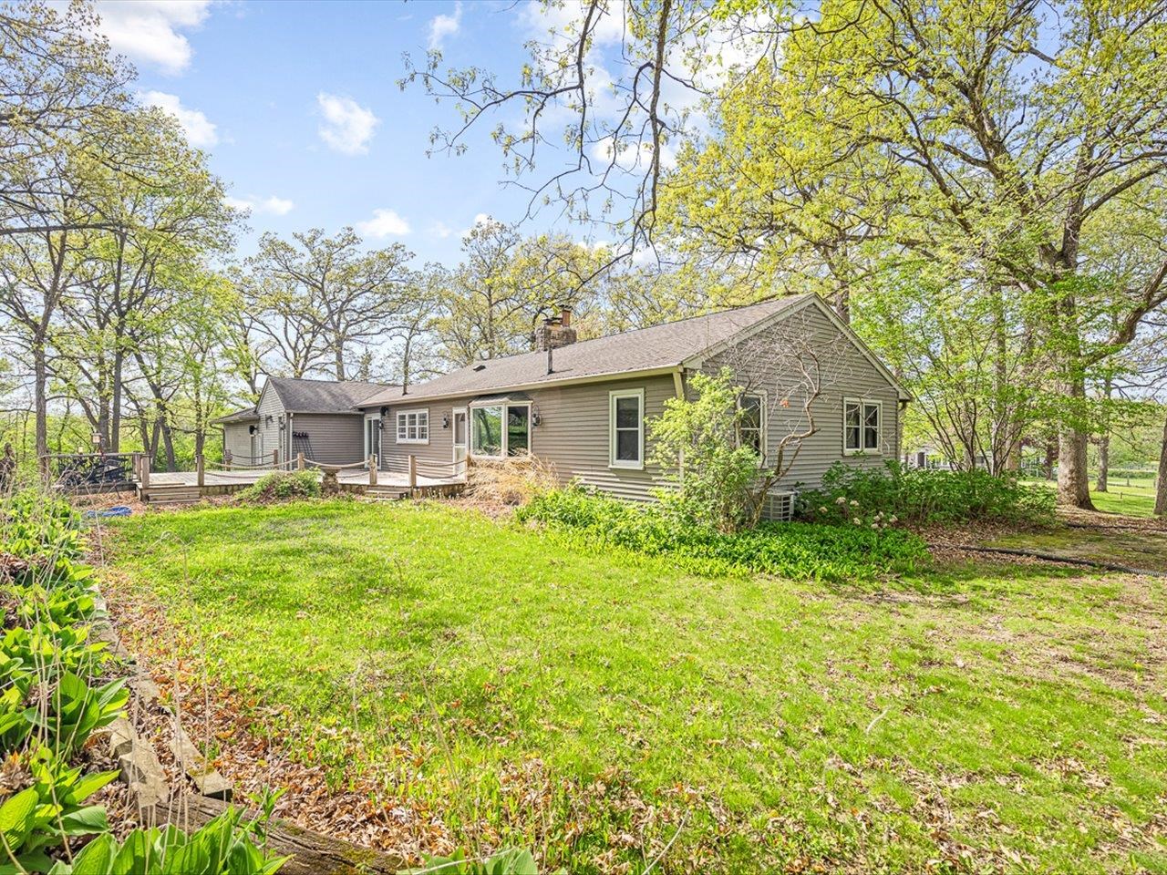 7785 Prairie Hill Road South Beloit, IL 61080 - Photo 9 of 46 a front view of a house with yard and green space