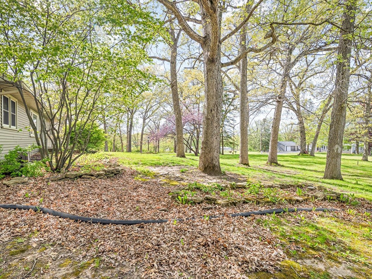 7785 Prairie Hill Road South Beloit, IL 61080 - Photo 10 of 46 a view of a house with a yard