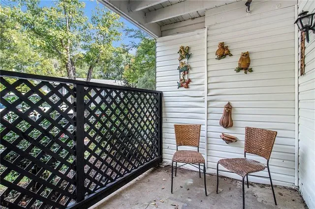 a view of a chairs and table in the balcony
