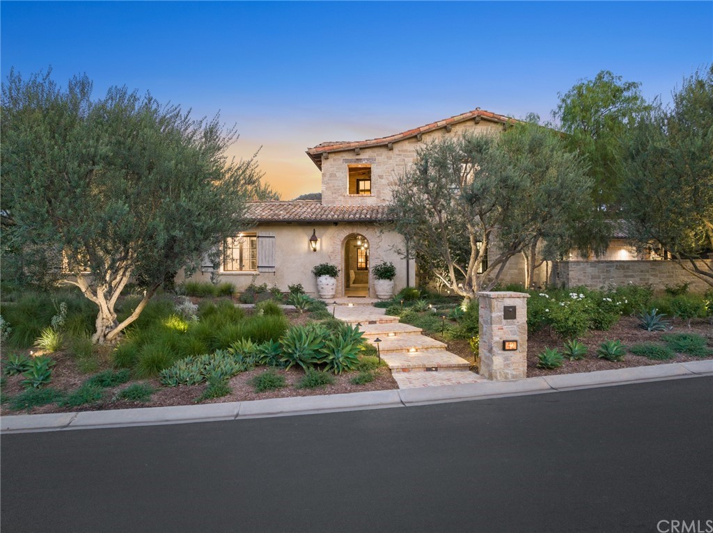 a front view of a house with a garden and street view